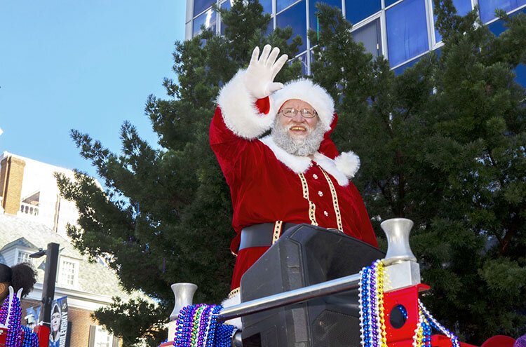 Santa Claus waves to the crowd as the holiday parade moves through downtown during the City of Tampa's 44th annual Santa Fest & Tree Lighting