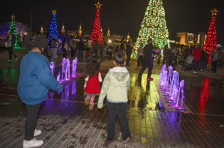 Following the ceremonial Christmas tree lighting, families enjoy festive fun under the lights before a showing of the holiday classic "Home Alone." 