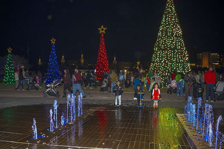 Following the ceremonial Christmas tree lighting, families enjoy festive fun under the lights before a showing of the holiday classic "Home Alone." 