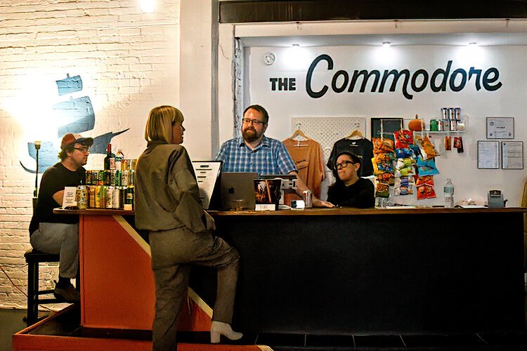 The Commodore’s team members speak with a visitor.