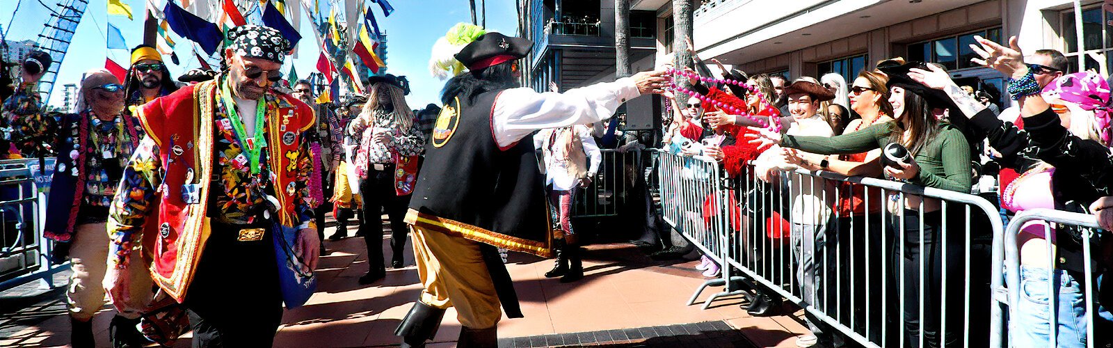 Gasparilla pirates toss colorful beads to revelers ready to catch them.