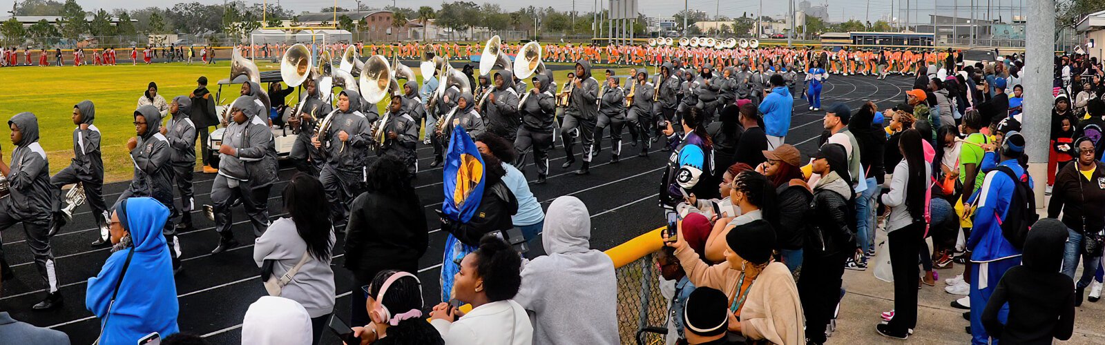 The Albany State University Marching Rams from Albany, Ga. enter the field at Gibbs High School while the orange-clad Stranahan High School band exits.