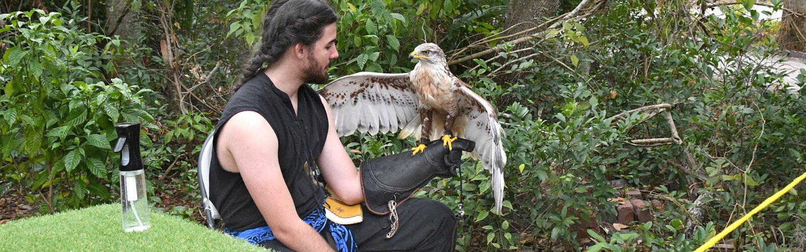 Udah, a ferruginous hawk endemic to the Midwest, and Tampa Bay Raptor Rescue handler Mikell at Boyd Hill Nature Preserve’s 11th annual Raptor Fest in St Petersburg.