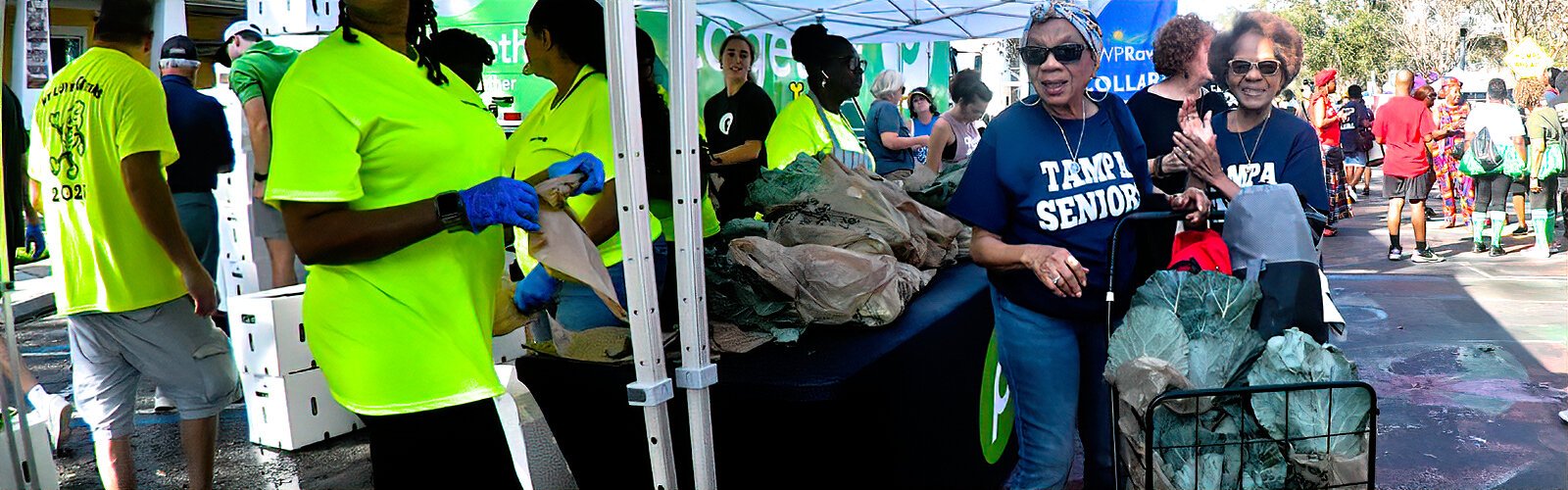 Publix volunteers give away WP Rawl-donated fresh collard green bunches, to the delight of festival goers.