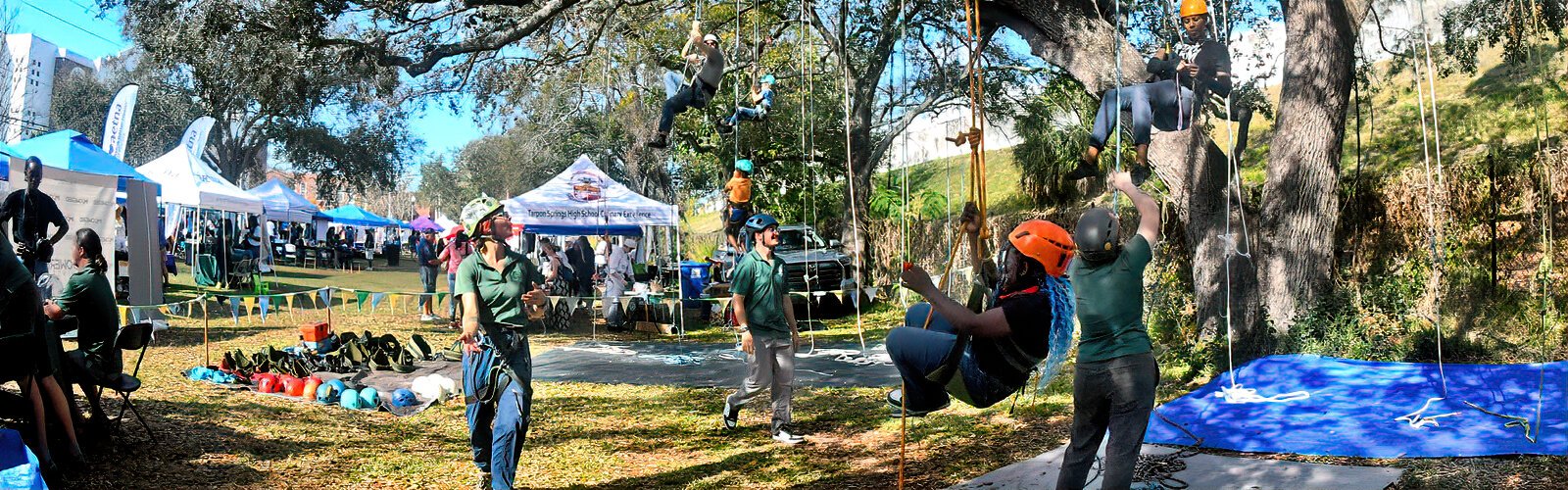 In the family zone, participants of all ages engage in rope tree-climbing organized by St Petersburg’s Pathfinder Outdoor Education. 