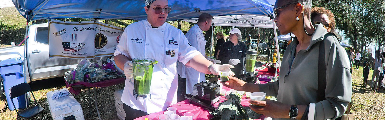 The American Culinary Federation offers the crowd samples of smoothies made with collard green, banana, and apple juice.