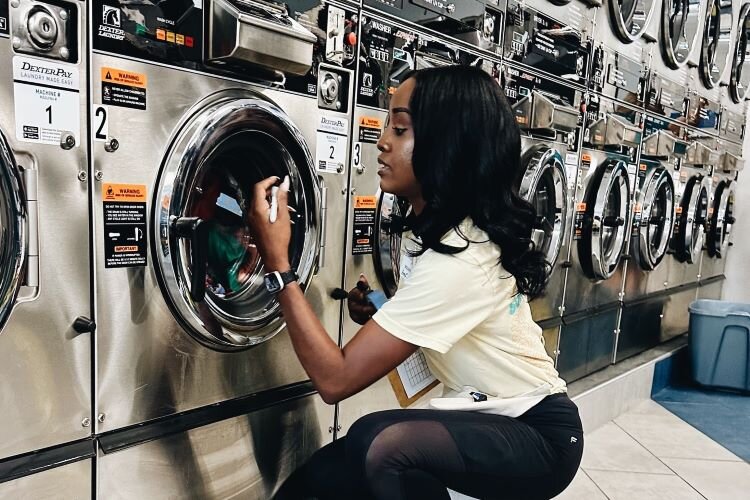 Laundry Project volunteers help community members with their wash and temporarily transform laundromats into community centers 