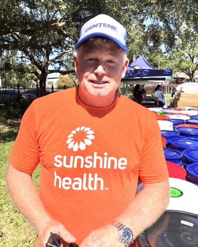 Troy Mills, an executive with Sunshine Health parent company Centene Corp., says volunteering at the hurricane relief event is "just being part of the community."